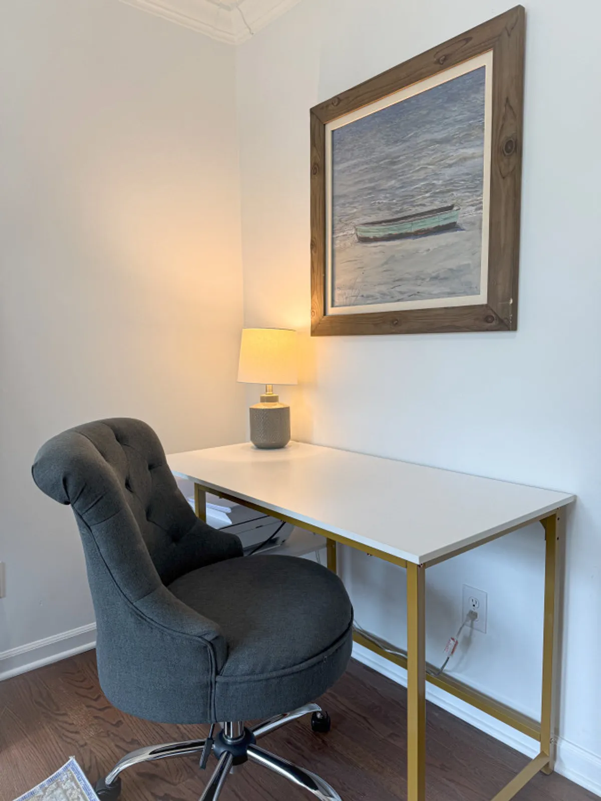 A serene workspace with a desk, comfortable chair, lamp, and thoughtfully chosen artwork. The setting is quiet and conducive to focused work, reading, or study, echoing the needs of business travelers.